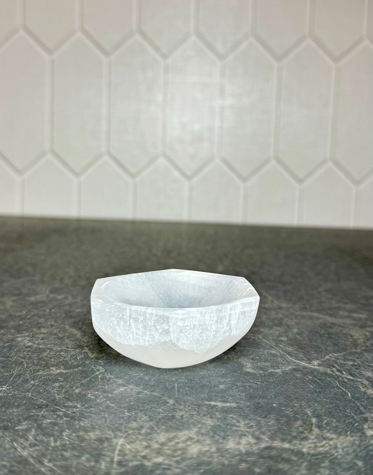 Front view of a white selenite hexagon bowl