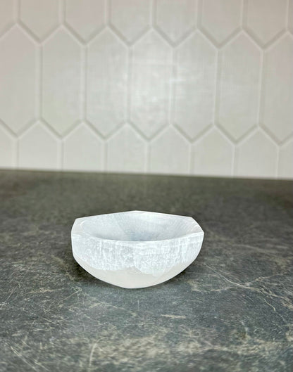 Front view of a white selenite hexagon bowl