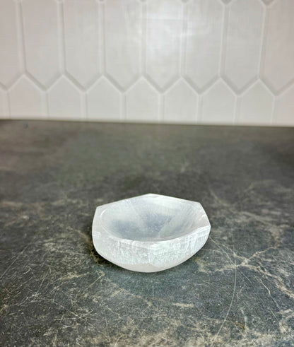 Side view of a white selenite hexagon bowl