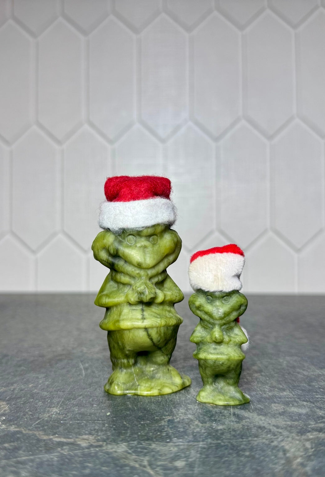Green jade Grinch carvings in both available sizes, front view