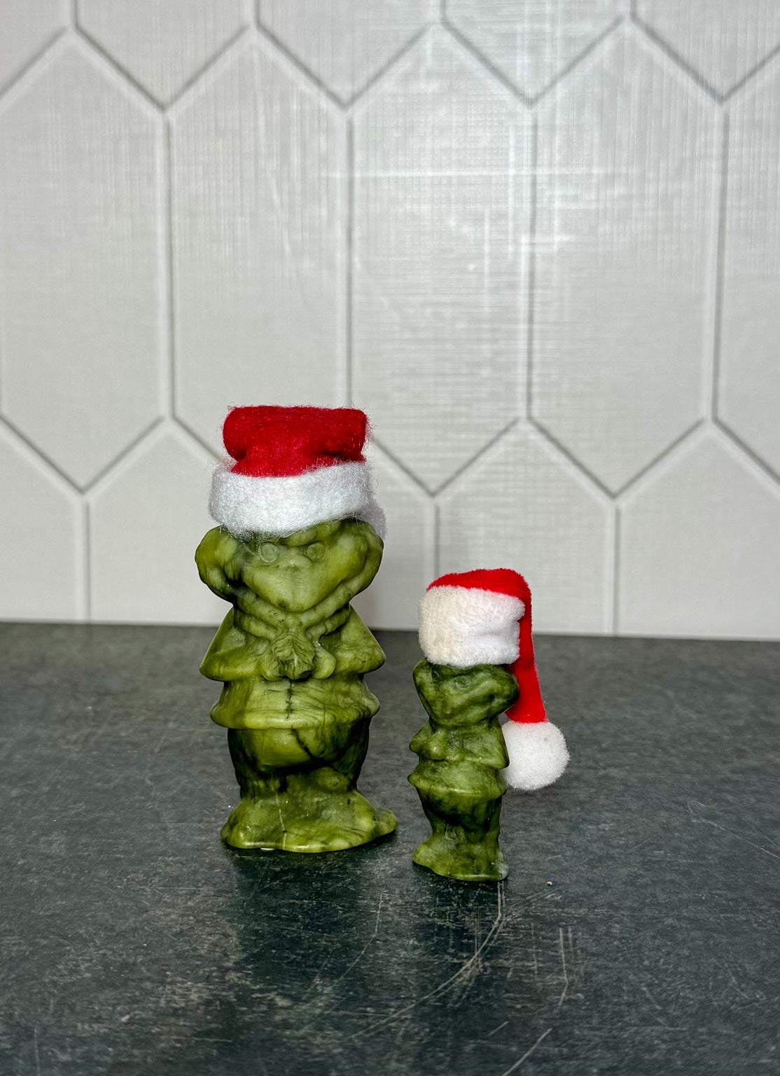 Green jade Grinch carvings in both available sizes, side view